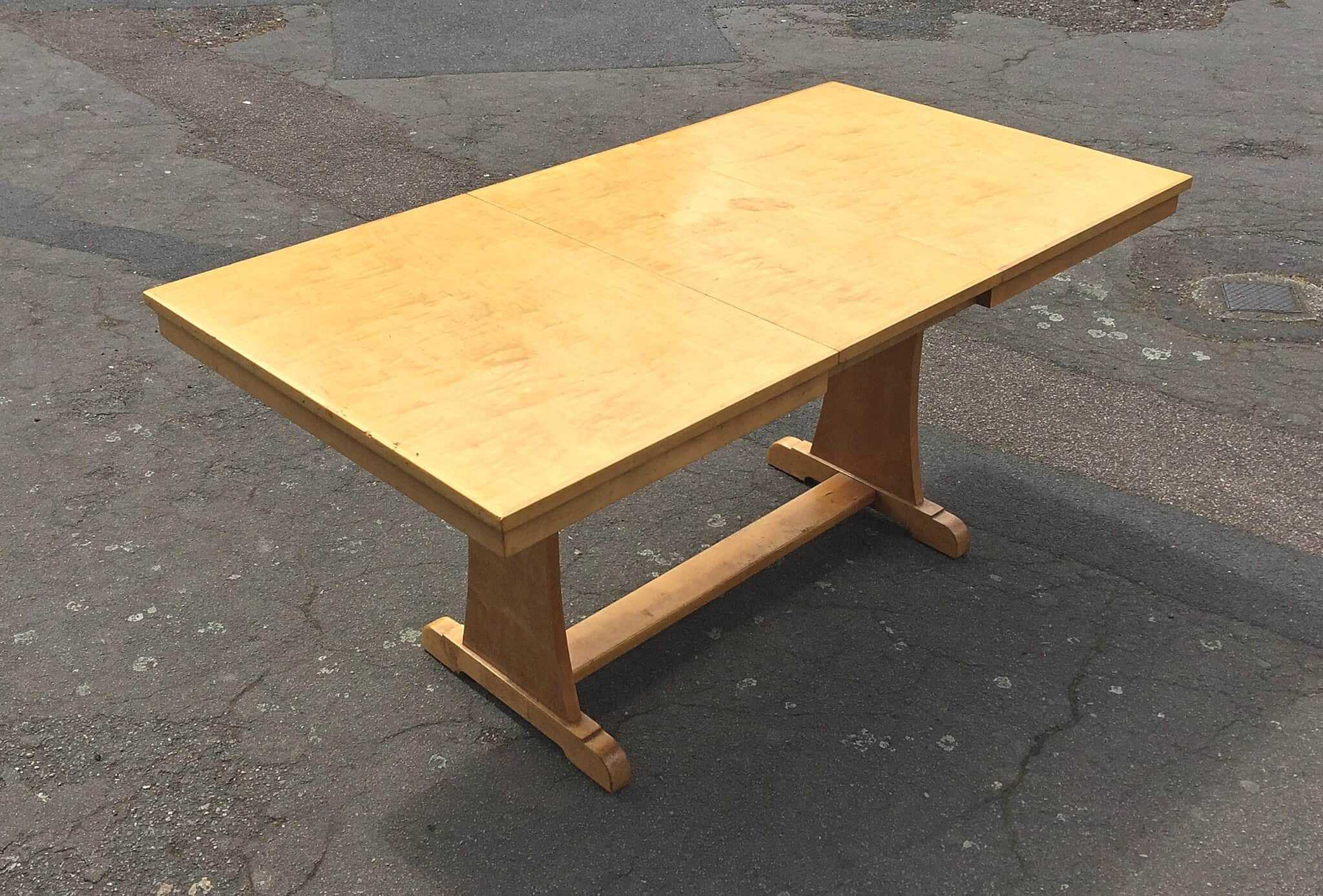 A 1930's Art Deco satin birch dining table with an extra leaf