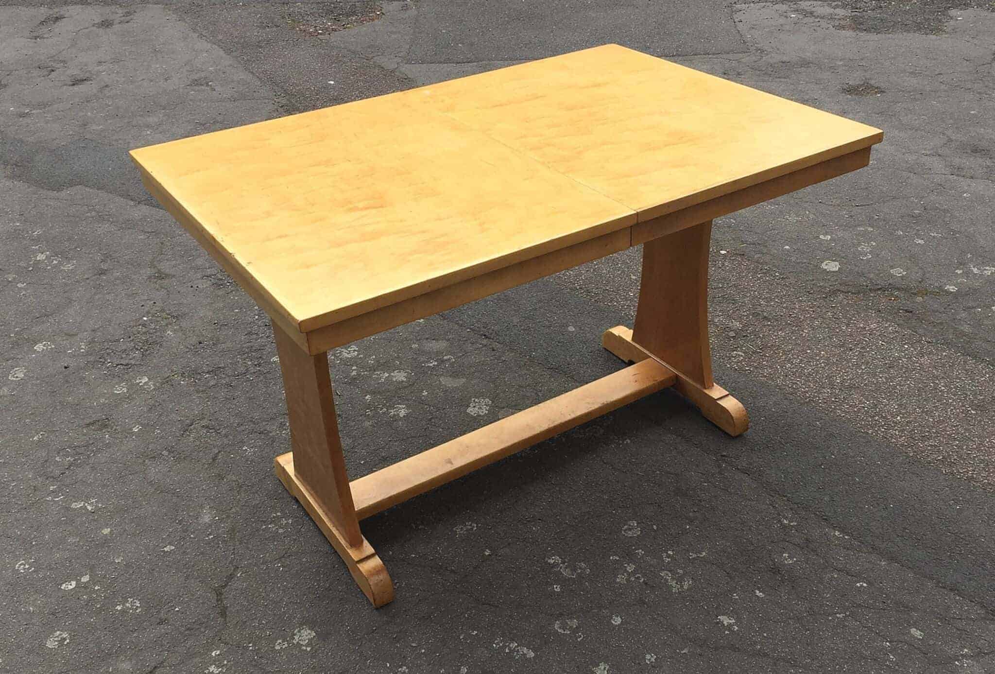 A 1930's Art Deco satin birch dining table with an extra leaf