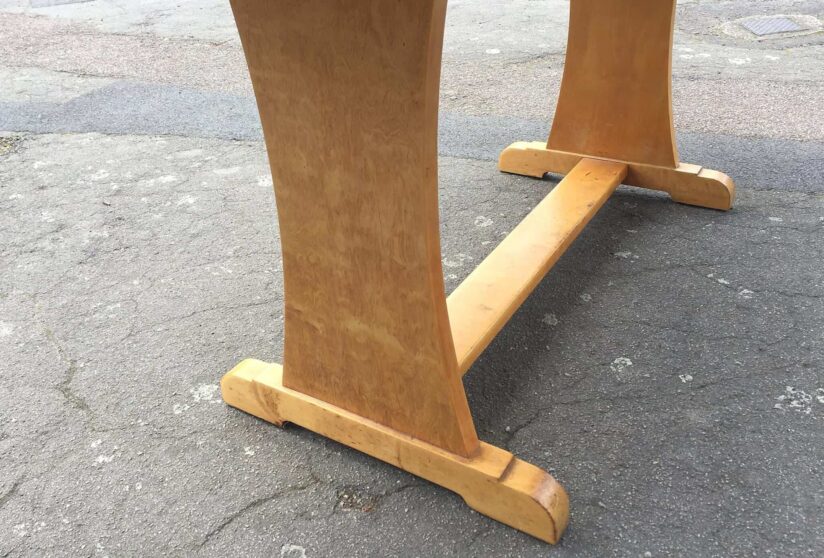 A 1930's Art Deco satin birch dining table with an extra leaf