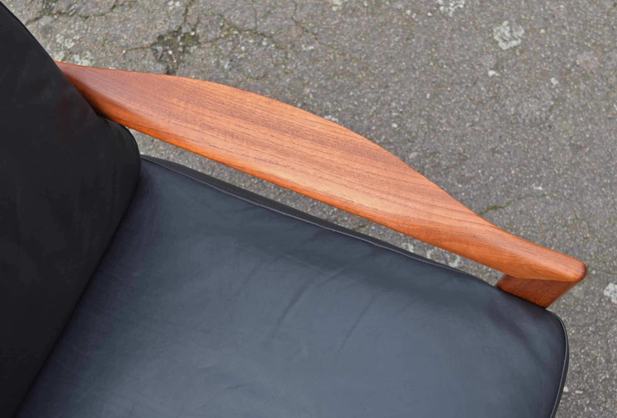 Close-up of swept teak arm of danish teak sofa